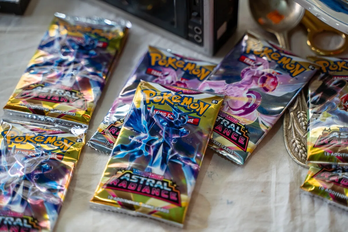 Sealed Pokémon Astral Radiance booster packs on a table