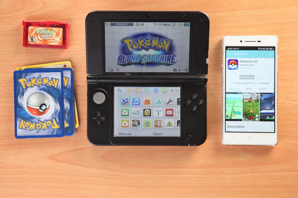 Pokémon games, a Game Boy cartridge and trading cards together