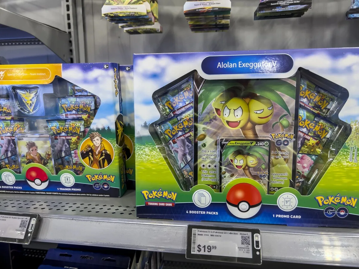 Pokémon booster packs and collection boxes on a store shelf